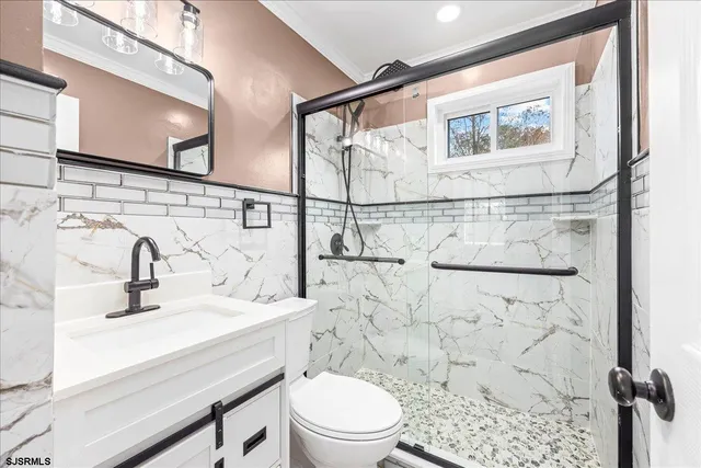 a bathroom with a sink toilet and shower