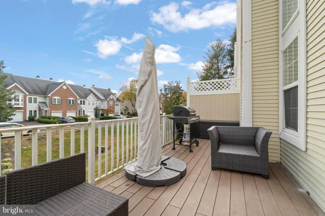 a view of a deck with couches and wooden floor