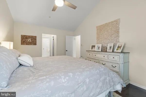 a bedroom with a large bed and a chandelier