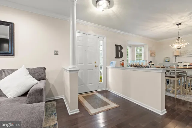 a living room with furniture and kitchen view