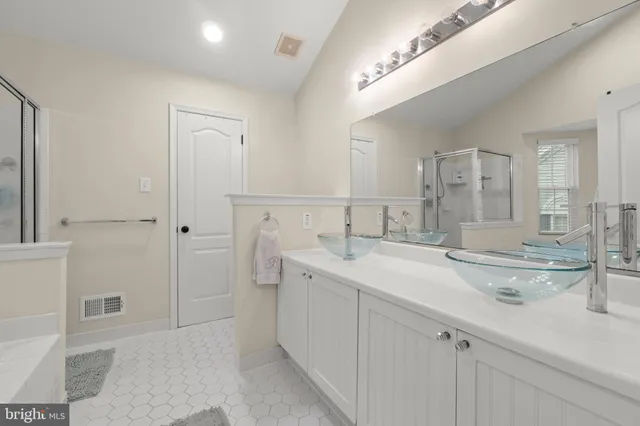 a bathroom with double sink and a mirror
