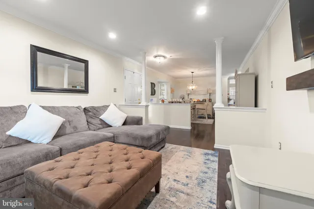 a living room with furniture and kitchen view