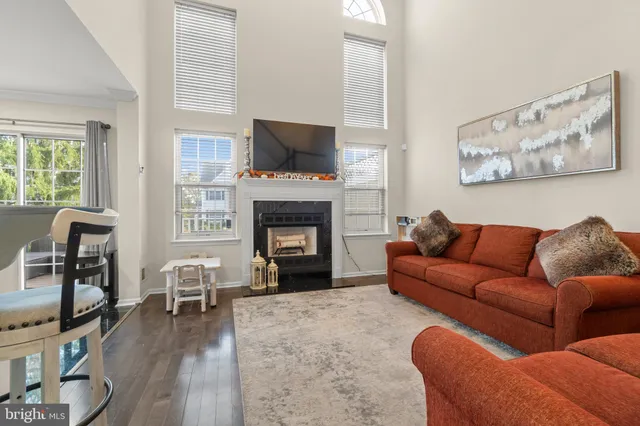 a living room with furniture fireplace and flat screen tv