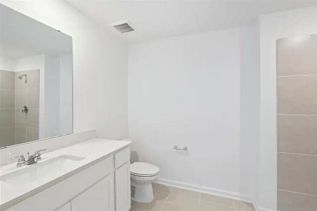 a bathroom with a sink vanity and toilet