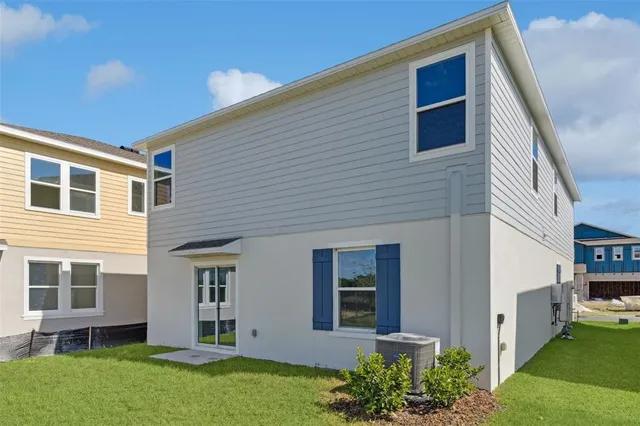 a view of house with backyard