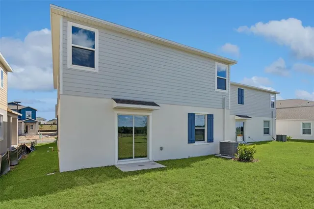 a view of an house with backyard space and a garden