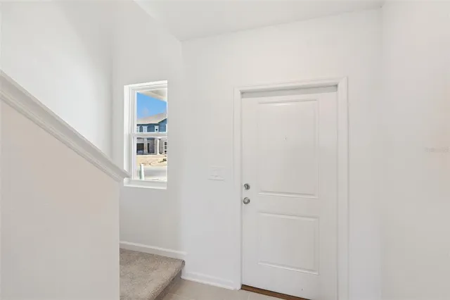 a view of hallway with window and closet