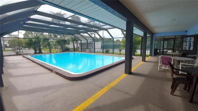 a swimming pool with outdoor seating and yard