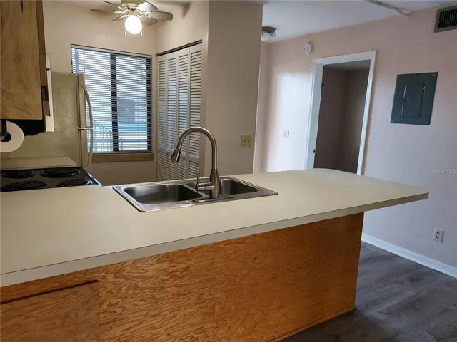 a kitchen with a table chairs and a refrigerator