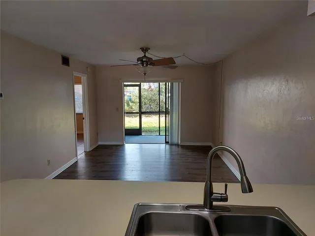 a view of a kitchen with a sink and window