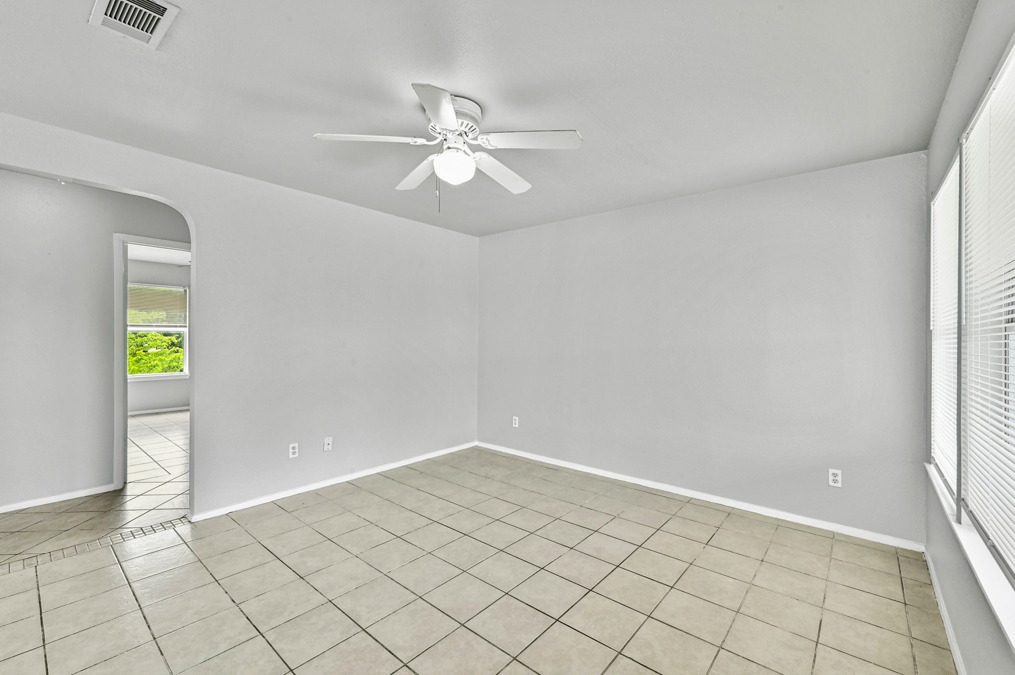 2212 Katy Lane Georgetown, TX 78626 - Photo 10 of 27 The room features a ceiling fan, tiled flooring, and windows with blinds