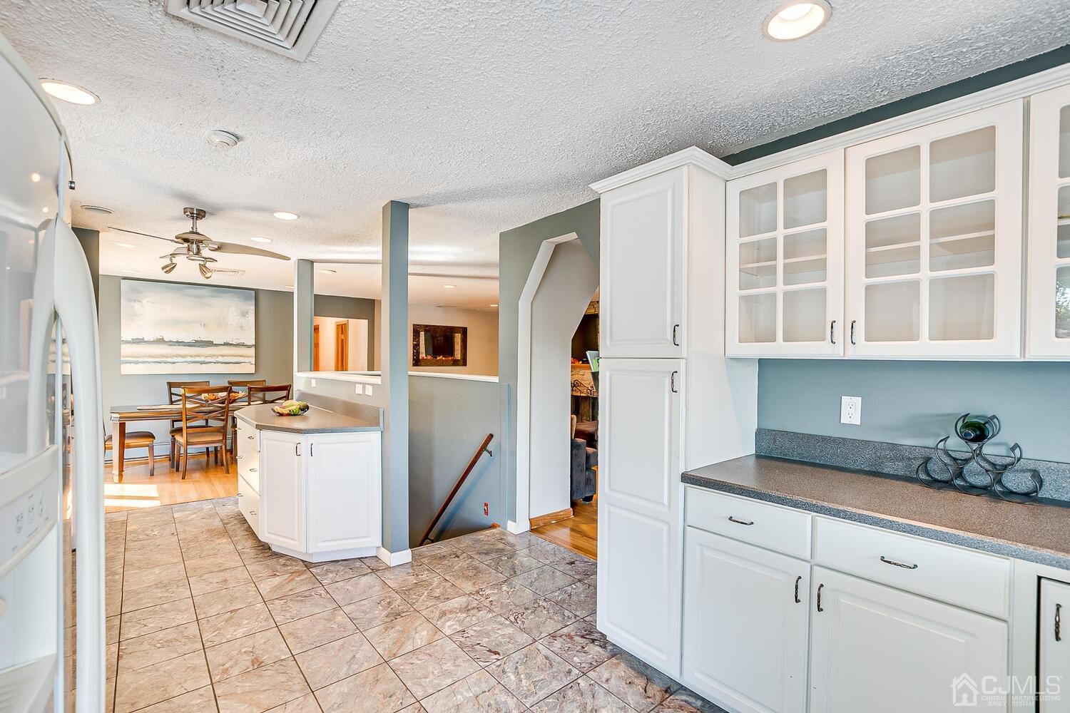 3 Normandy Road Colonia, NJ 07067 - Photo 13 of 40 a kitchen with cabinets and chairs