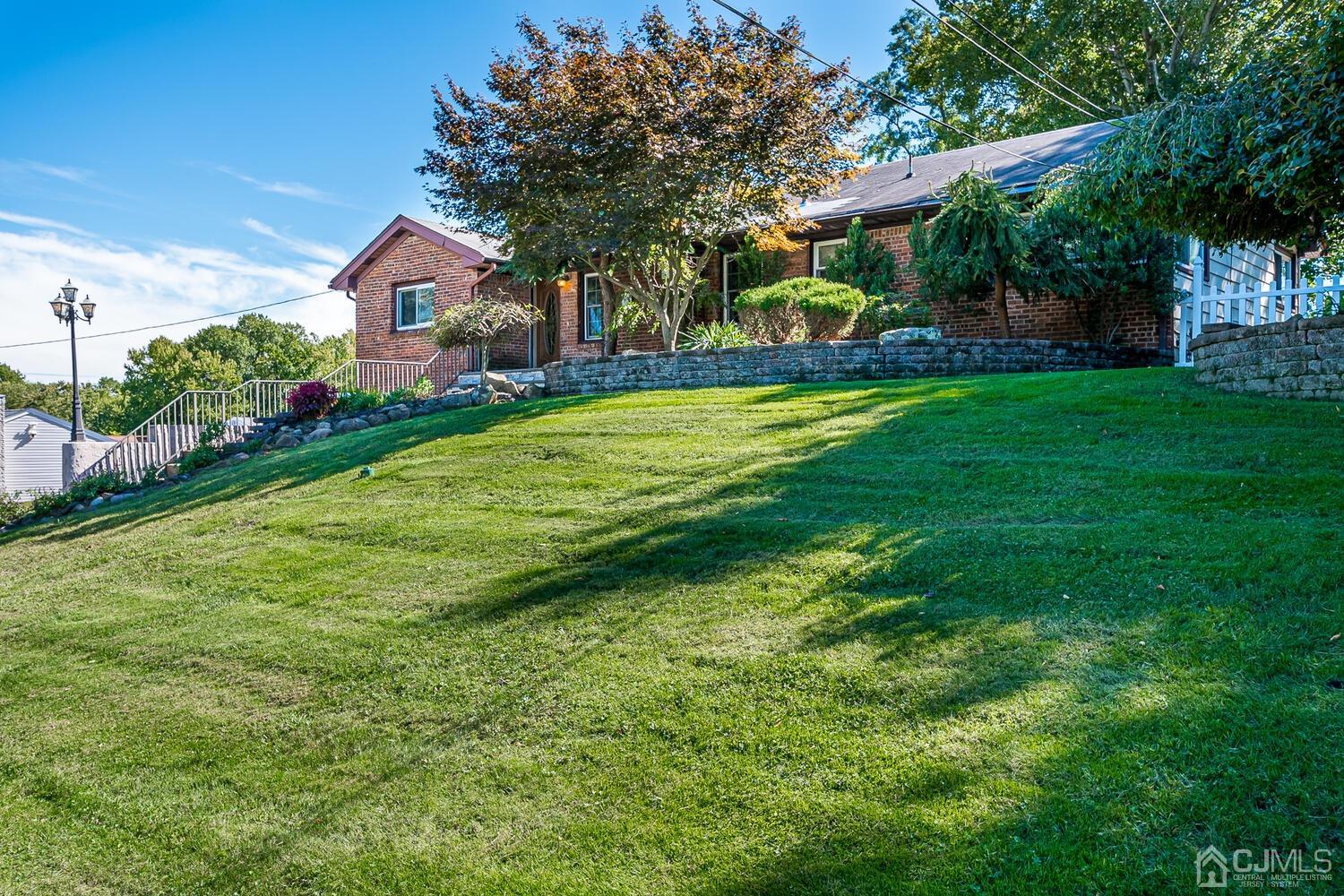 3 Normandy Road Colonia, NJ 07067 - Photo 3 of 40 a front view of a house with garden and tree