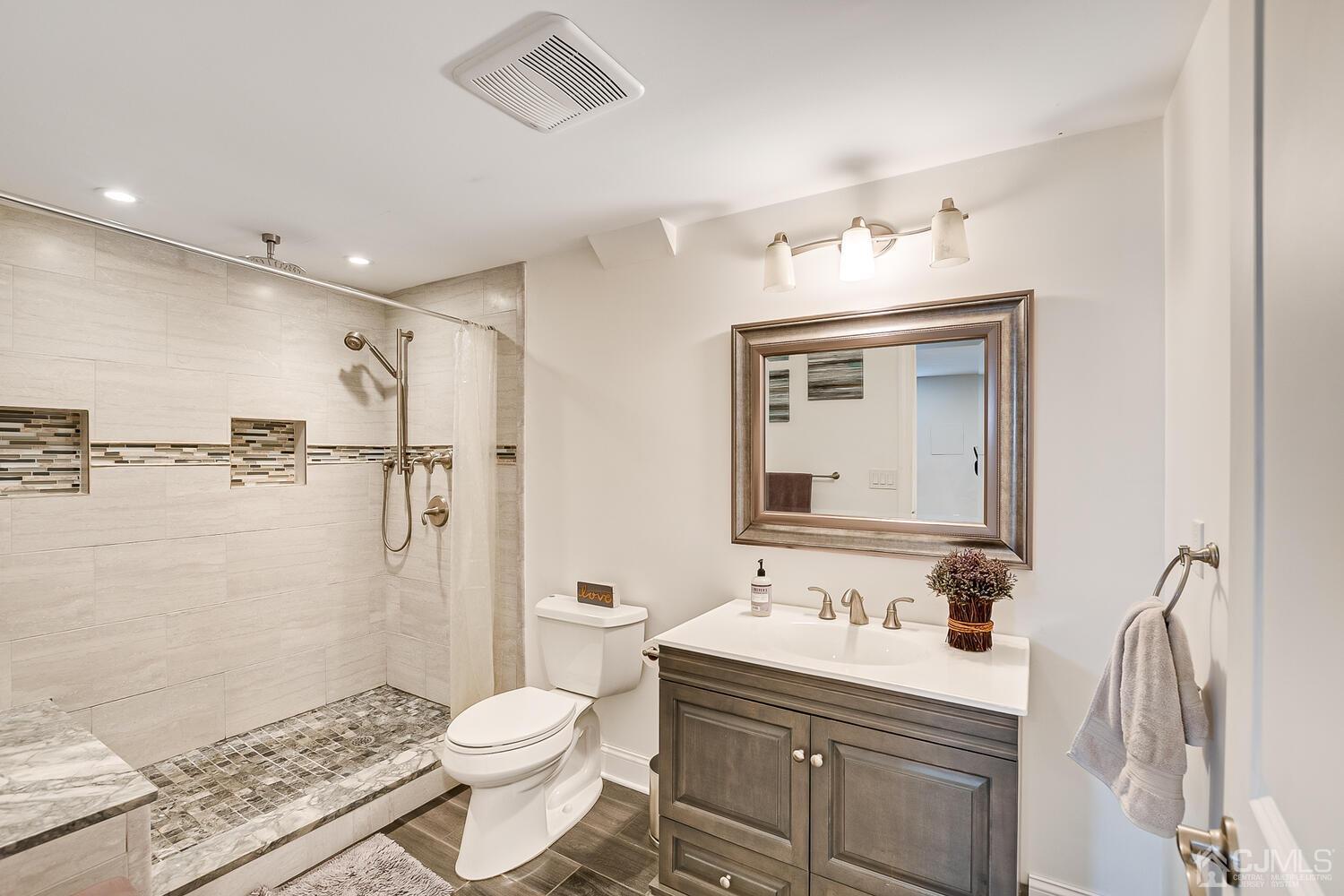 3 Normandy Road Colonia, NJ 07067 - Photo 25 of 40 a bathroom with a sink a toilet and shower