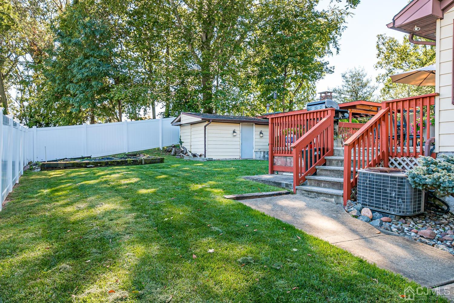 3 Normandy Road Colonia, NJ 07067 - Photo 27 of 40 a view of a small house in a yard with wooden fence