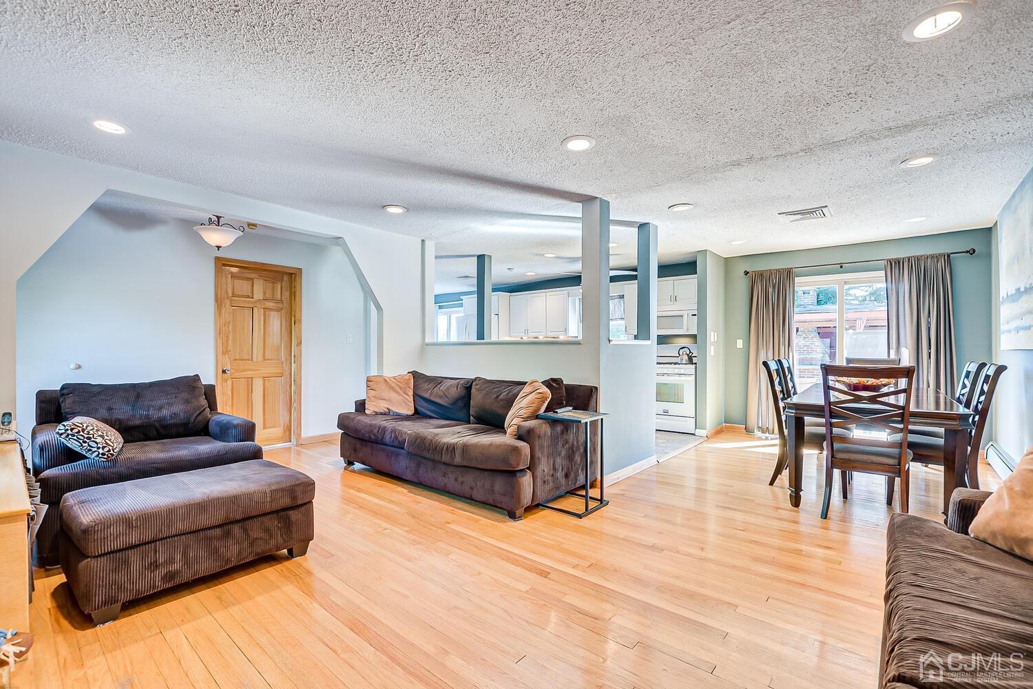3 Normandy Road Colonia, NJ 07067 - Photo 6 of 40 a living room with furniture and a wooden floor