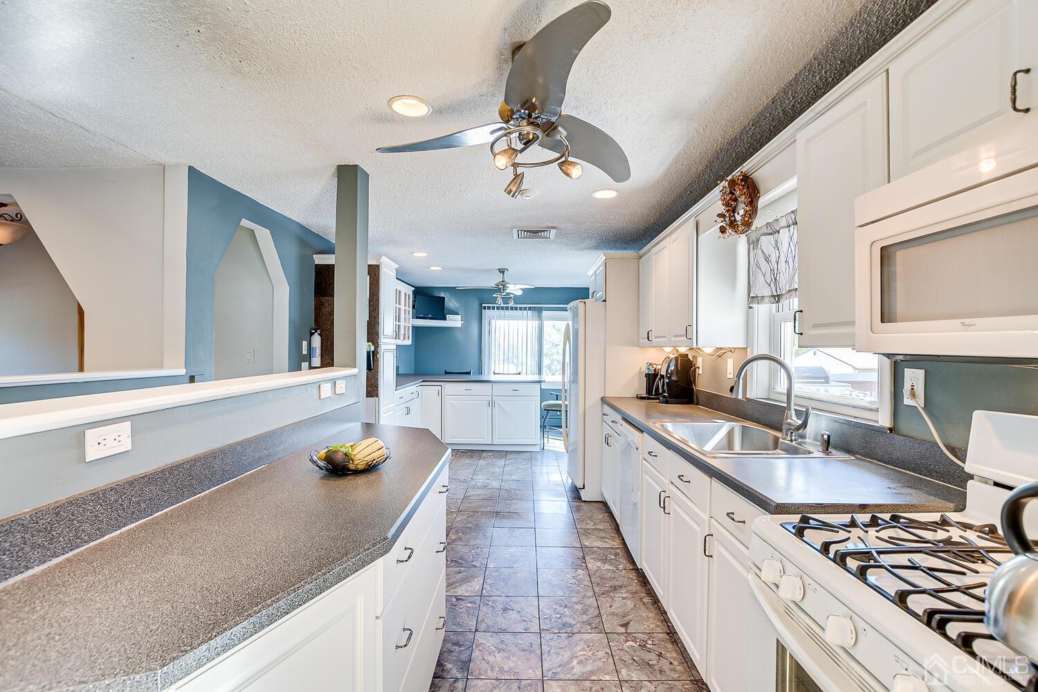 3 Normandy Road Colonia, NJ 07067 - Photo 9 of 40 a kitchen with stainless steel appliances granite countertop a sink stove and refrigerator
