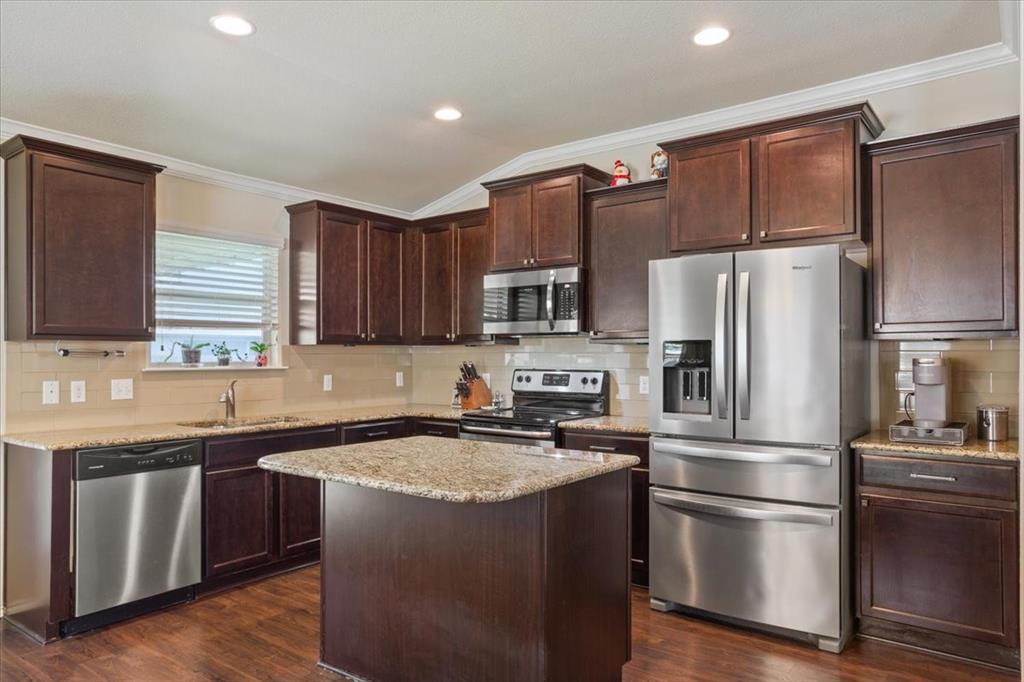 5308 Tama Drive Waco, TX 76708 - Photo 11 of 29 a kitchen with wooden cabinets and stainless steel appliances