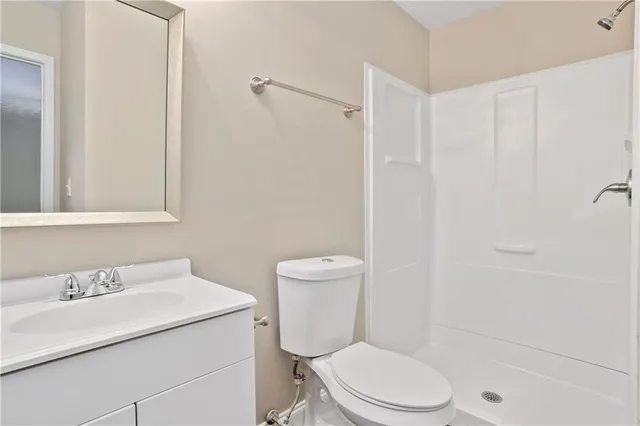 a white toilet sitting next to a bathroom sink