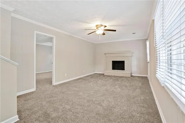 a view of empty room with a fireplace