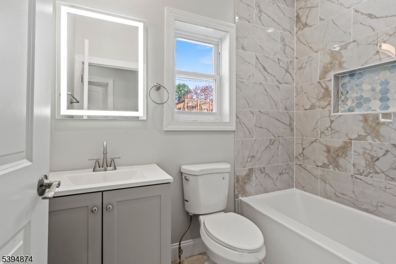 53 Marcy Avenue, Unit 1 East Orange, NJ 07017 - Photo 12 of 23 a bathroom with a sink toilet and shower