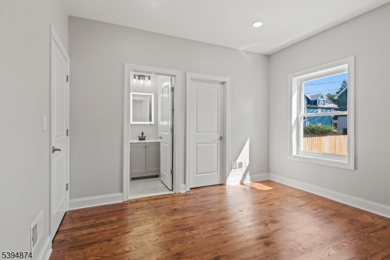 53 Marcy Avenue, Unit 1 East Orange, NJ 07017 - Photo 14 of 23 a view of empty room with window and wooden floor