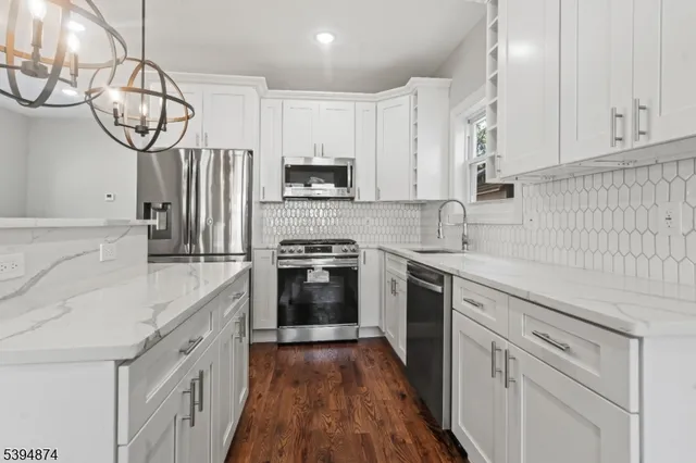 a kitchen with cabinets appliances and a counter space