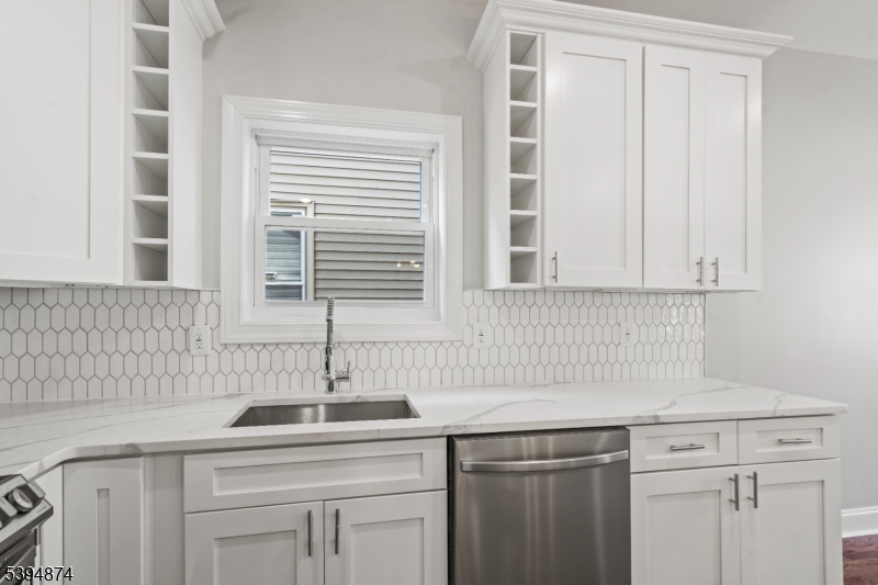 53 Marcy Avenue, Unit 1 East Orange, NJ 07017 - Photo 4 of 23 a kitchen with stainless steel appliances granite countertop a sink and a window