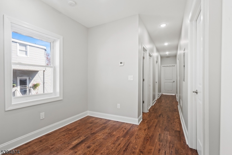 53 Marcy Avenue, Unit 1 East Orange, NJ 07017 - Photo 9 of 23 a view of a room with wooden floor and a window
