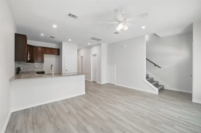 a view of kitchen with cabinets and wooden floor