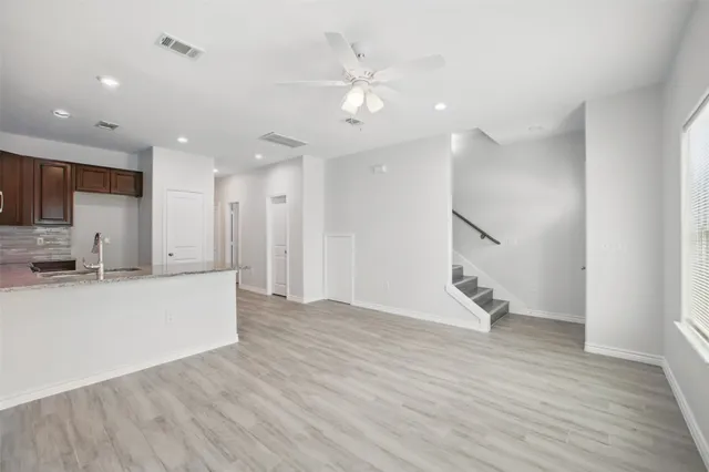 a view of kitchen with wooden floor and electronic appliances