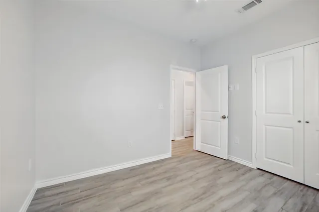 a view of an empty room and wooden floor