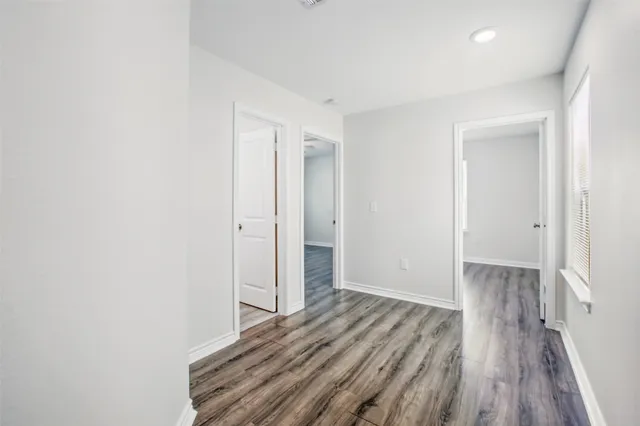 a view of a room with wooden floor