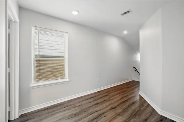 a view of room with window and wooden floor