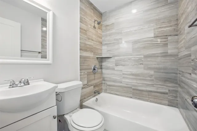 a bathroom with a toilet a sink and bathtub