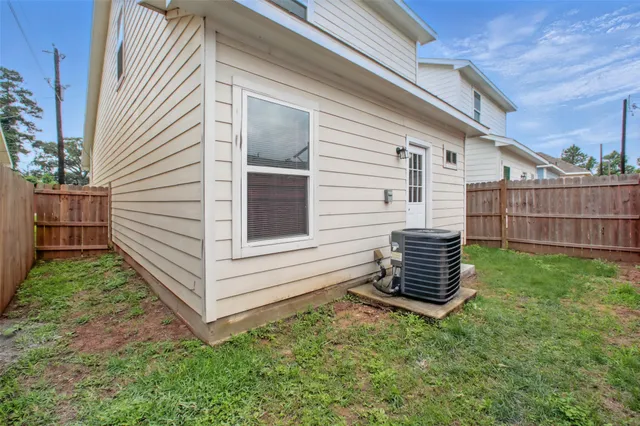 a view of a house with a yard and wooden fence