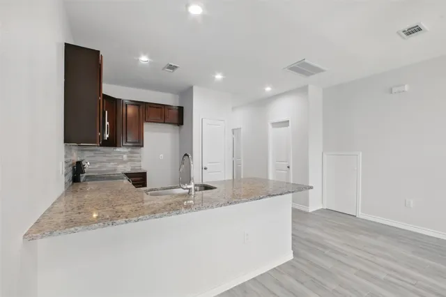 a large bathroom with a granite countertop sink and a large mirror