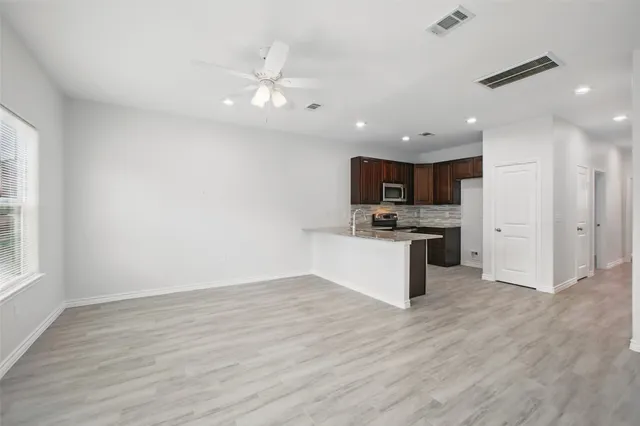 a view of kitchen with granite countertop cabinets and stainless steel appliances