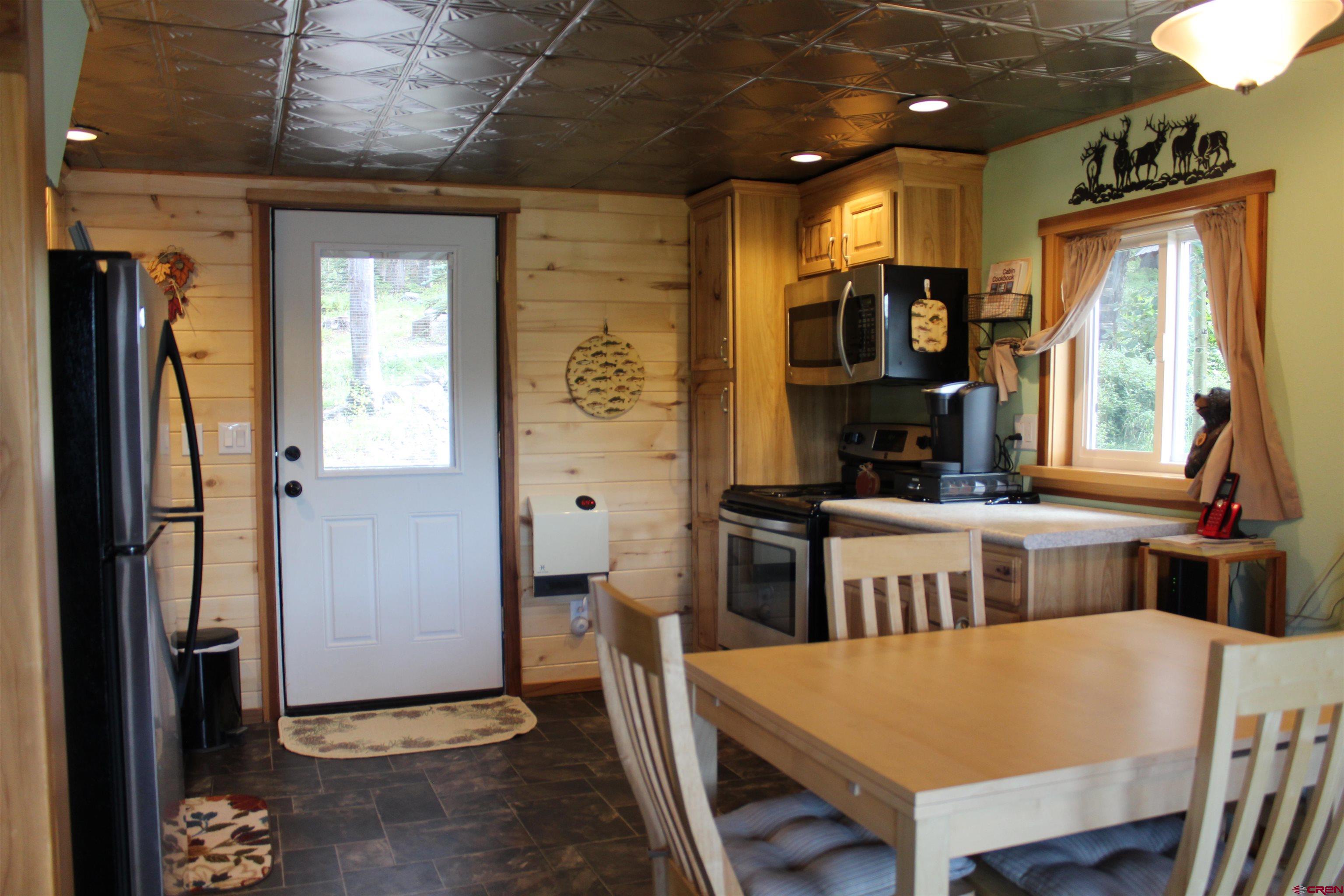 21629 Baron Lake Drive Cedaredge, CO 81413 - Photo 11 of 34 a large kitchen with a table and chairs