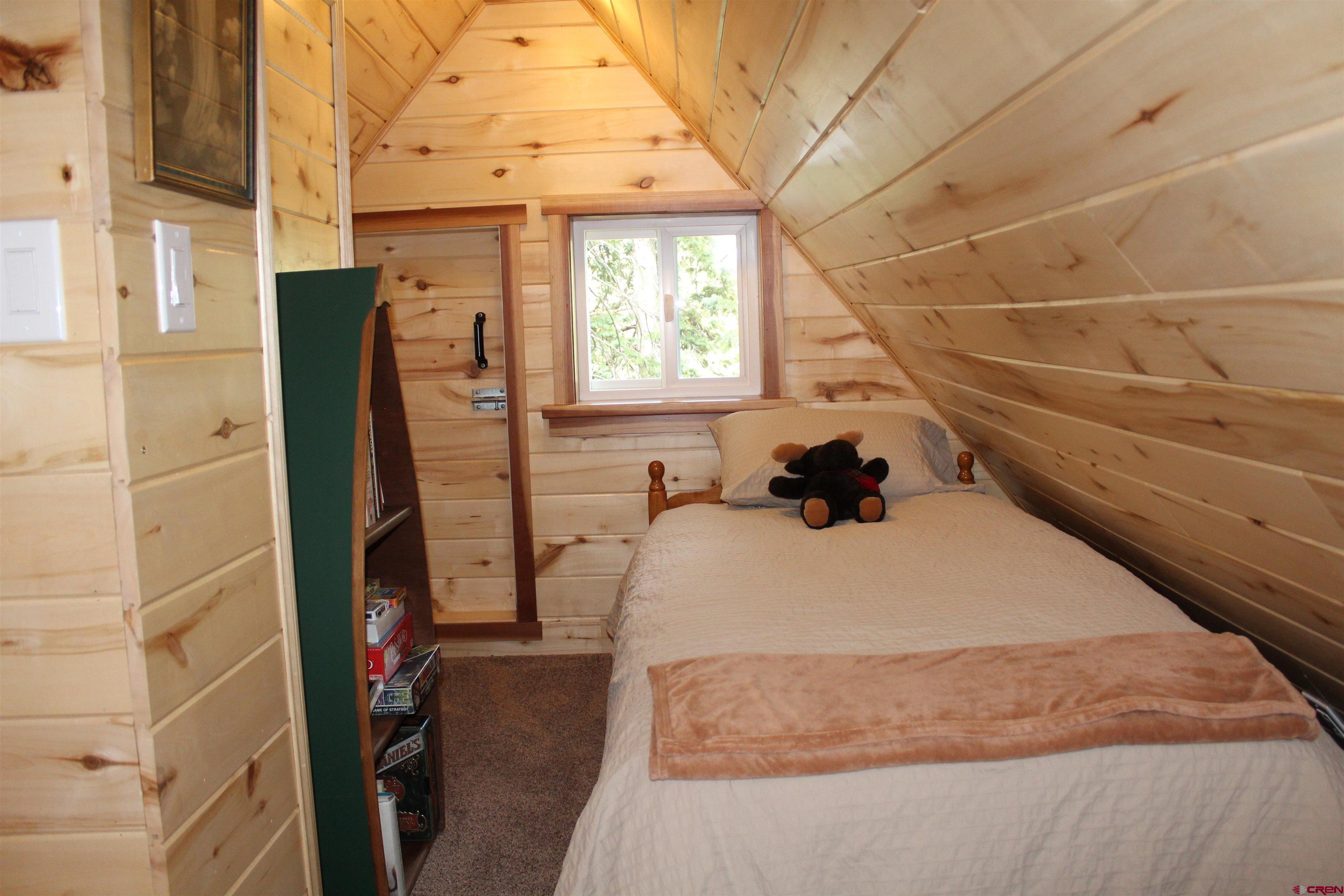 21629 Baron Lake Drive Cedaredge, CO 81413 - Photo 17 of 34 a bedroom with a bed and a window