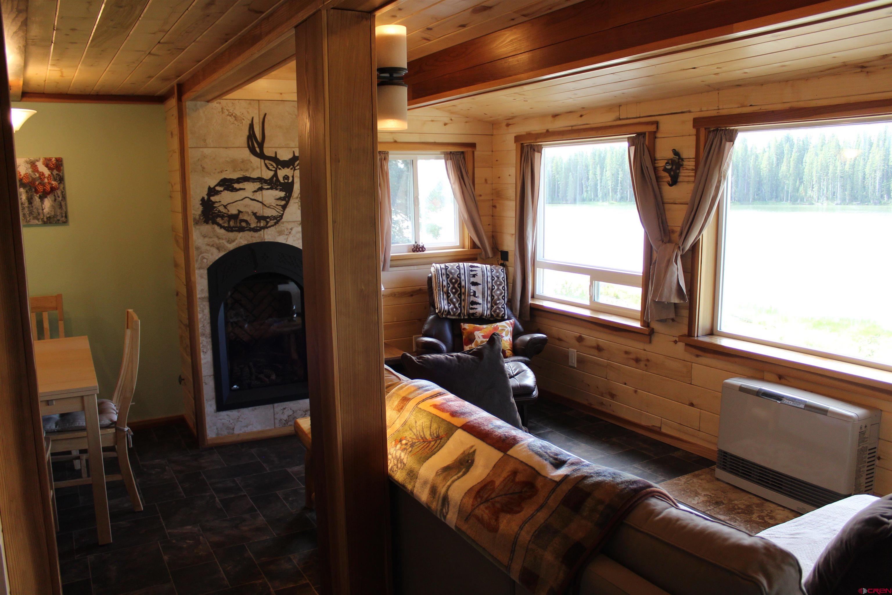 21629 Baron Lake Drive Cedaredge, CO 81413 - Photo 28 of 34 a living room with furniture and a fireplace