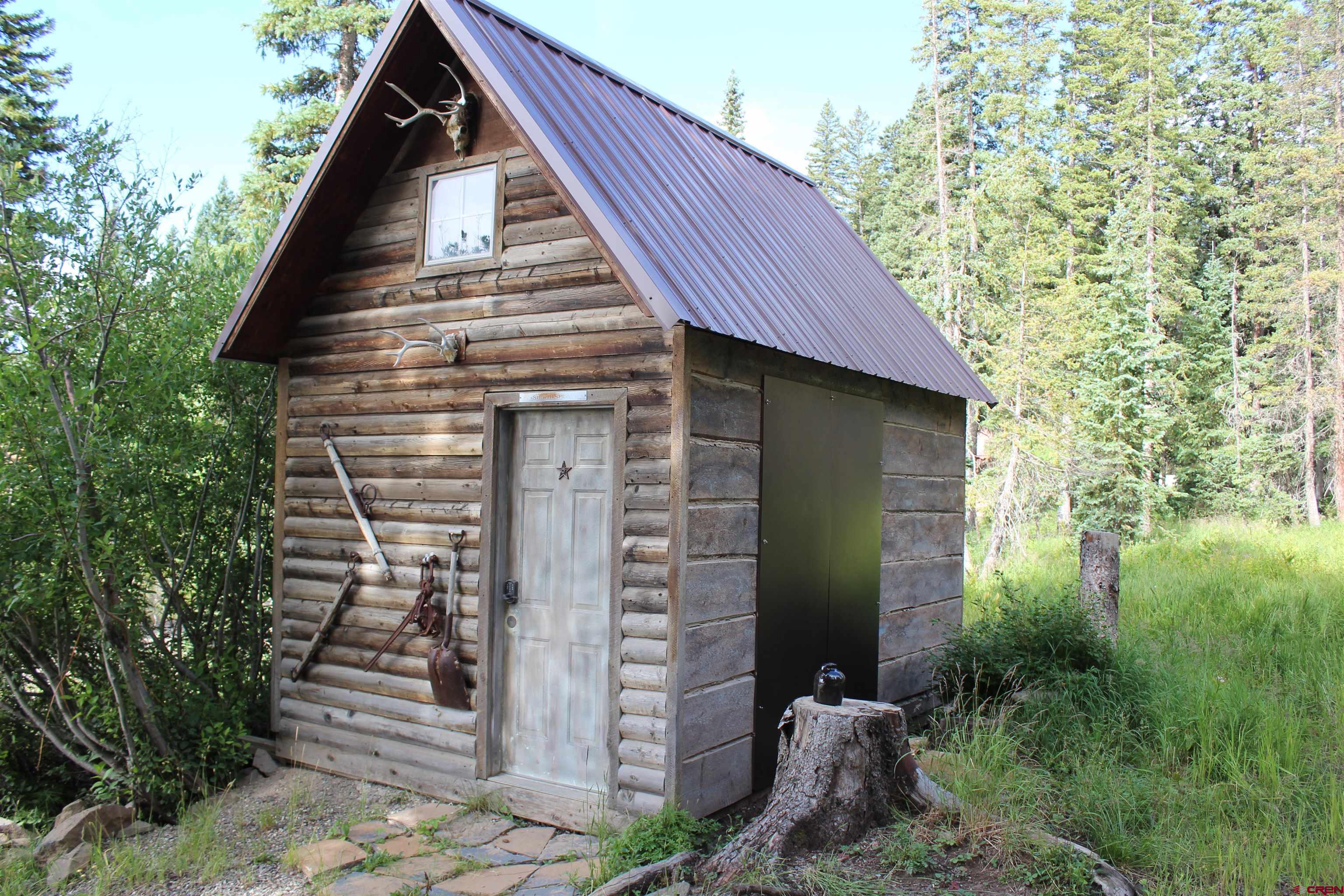 21629 Baron Lake Drive Cedaredge, CO 81413 - Photo 30 of 34 a view of a house with brick walls and plants
