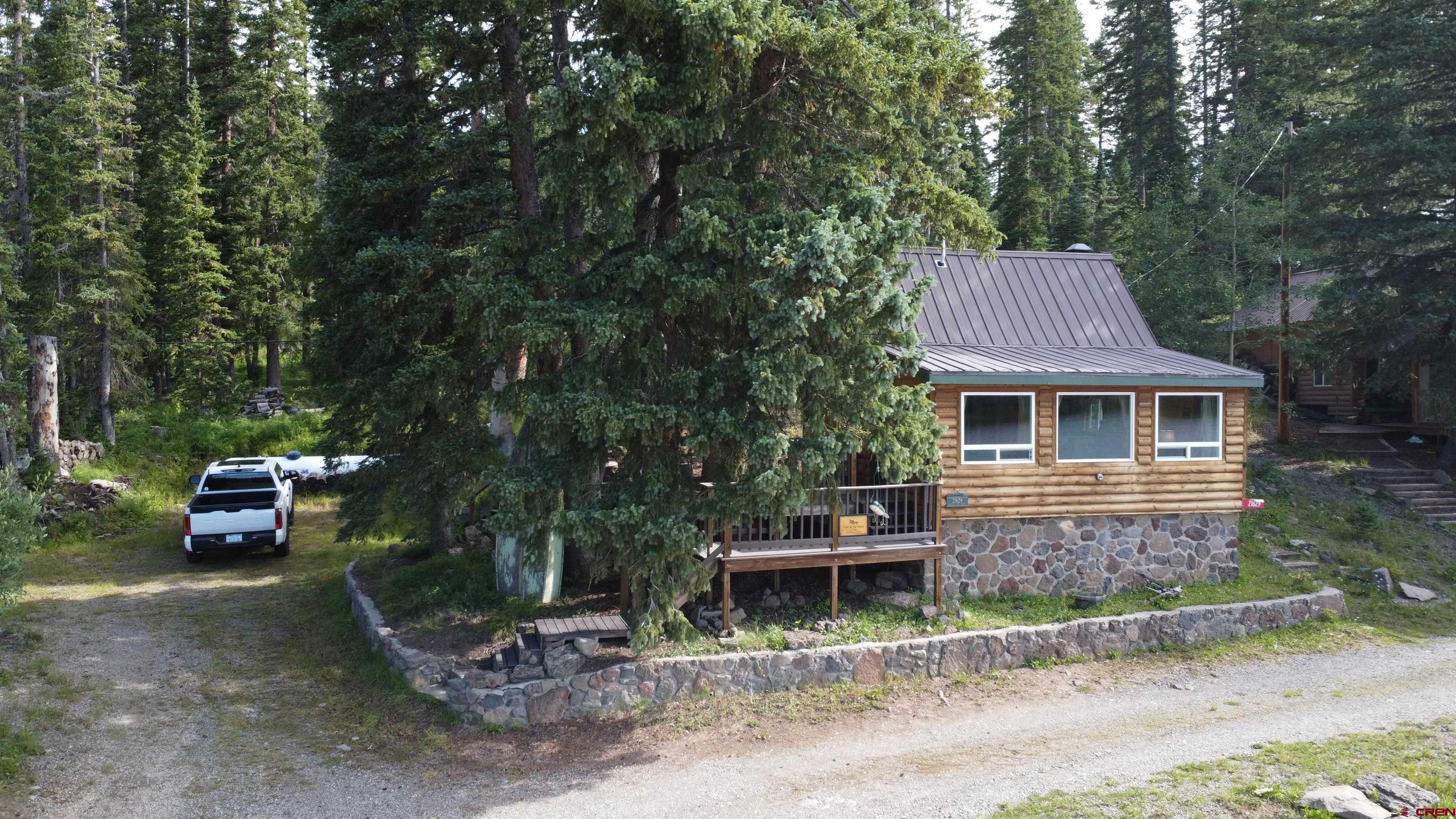 21629 Baron Lake Drive Cedaredge, CO 81413 - Photo 32 of 34 a view of a house with backyard and sitting area
