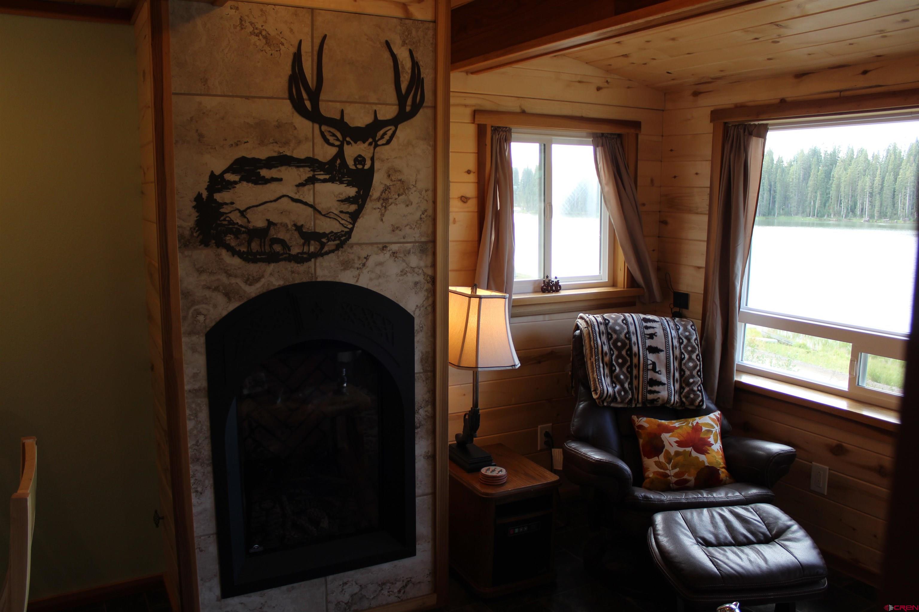 21629 Baron Lake Drive Cedaredge, CO 81413 - Photo 10 of 34 a living room with furniture and a fireplace