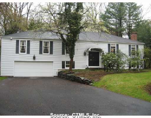11 Shepard Road Woodbridge, CT 06525 - Photo 1 of 1 a front view of a house with a garden and garage