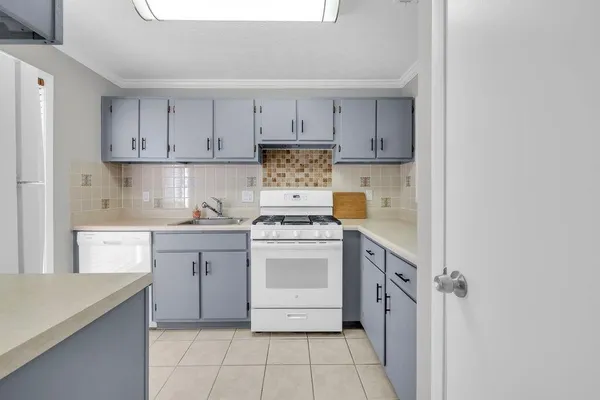 a kitchen with a stove top oven sink and cabinets