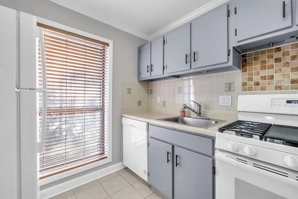 a kitchen with cabinets appliances and a window