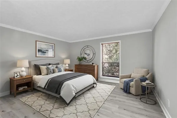 a bedroom with a bed a couch and a window