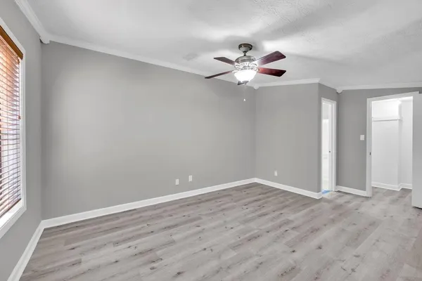 wooden floor in an empty room with a window