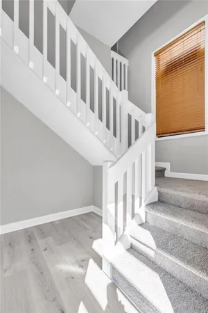 a view of staircase with white walls and windows